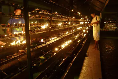 A Man Lights a Candle in the Garden