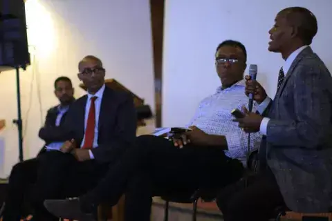 KAICIID Fellow Geleta Simesso sits with three other Ethiopian men